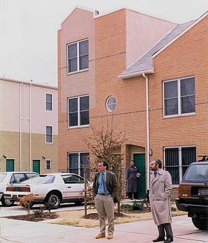 Johnnie Tillmon: men in front of houses